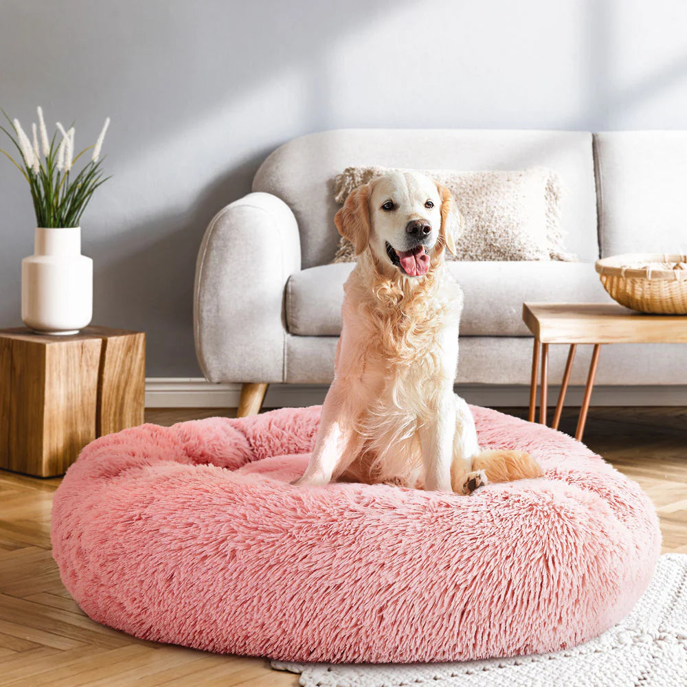 Pink plush pet bed with soft cushioning, offering a cozy and stylish spot for cats and dogs to nap